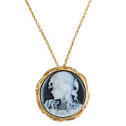 Broche colgante camafeo redondo en metal dorado. Figura mujer color crema con fondo gris. Rodeado de brillantes de strass. Diámetro de 4,5 cm. Se puede usar como colgante.