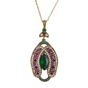 Colgante herradura oval de plata dorada con esmeraldas y rubíes naturales